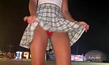 Brunette teen shows off her panties and dances in public